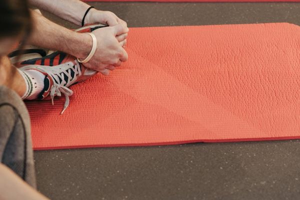 Close up of yoga stretching exercise on a mat